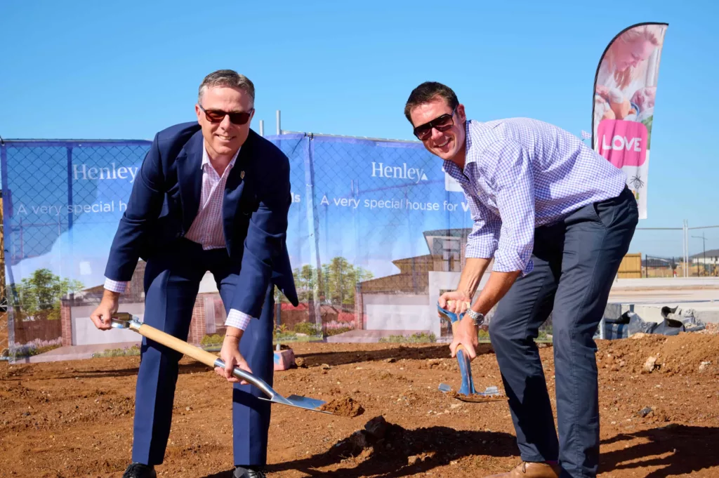 Michael Wasley and Ben Griffiths are outside on the site where the new home will be built.